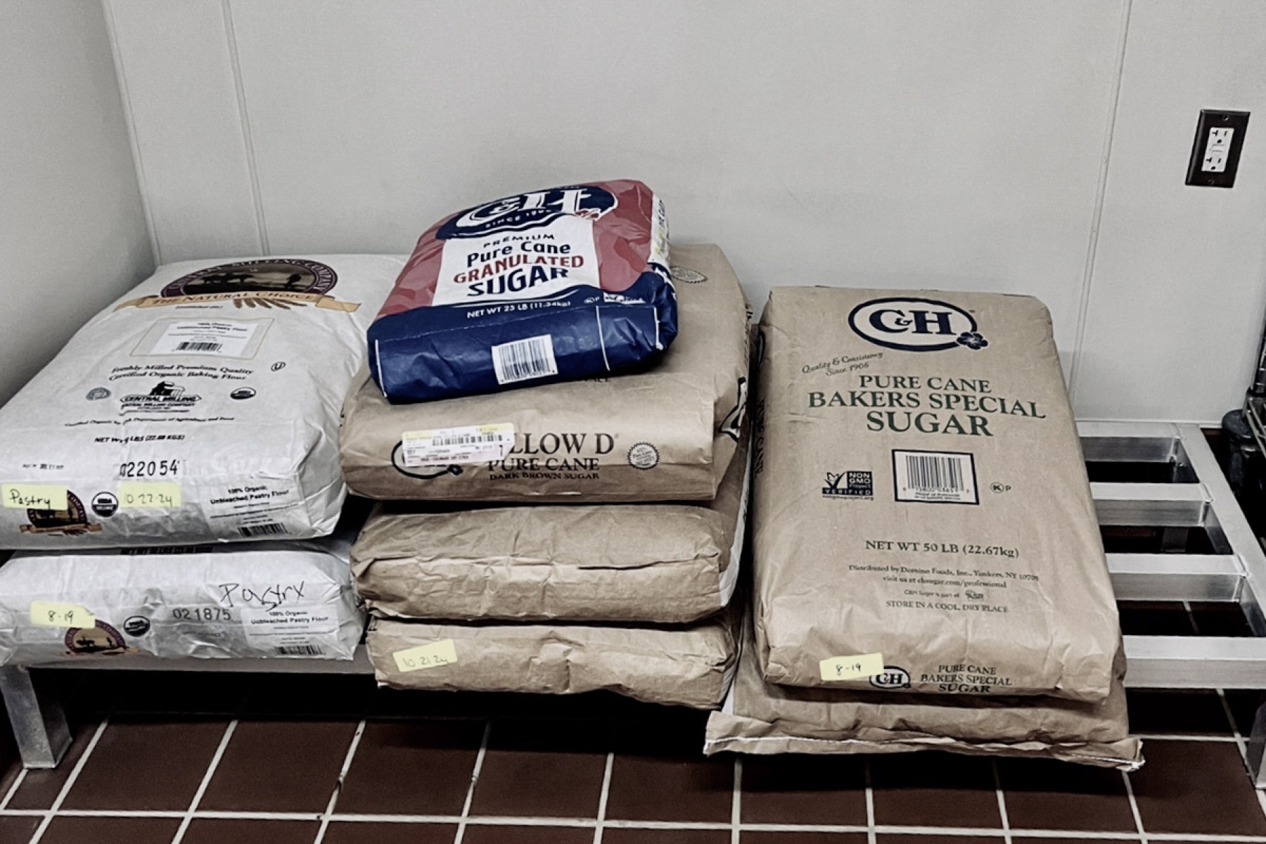 Bulk sugar and flour storage on dunnage racks in the culinary center